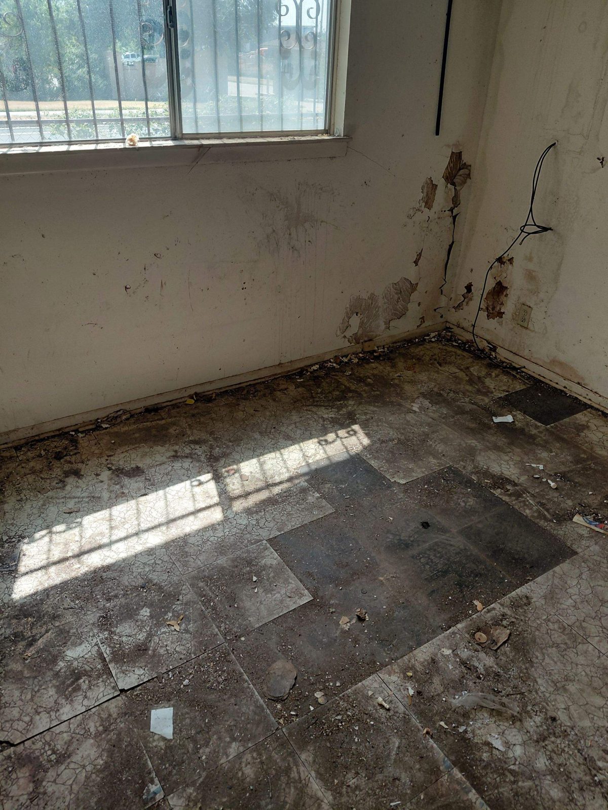 Tiled room with wall damage at 1203 Rossolis Dr